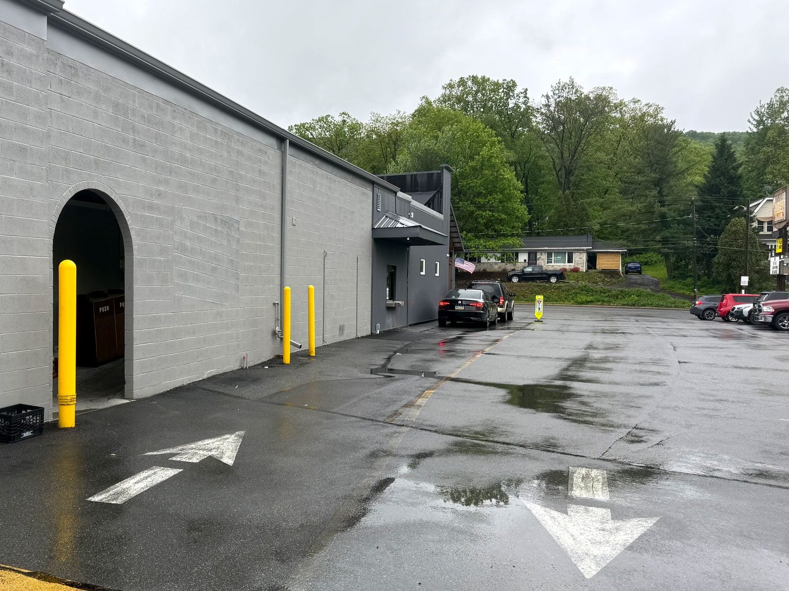 The drive-thru lane at The Coney Island in Pottsville, PA, with painted arrows leading up to the window.