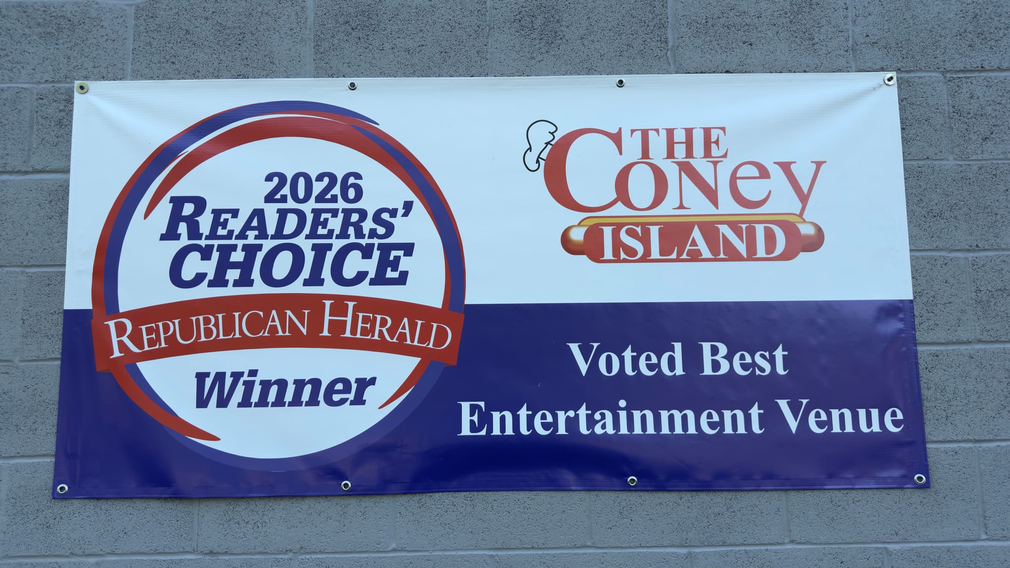 The 2026 Readers' Choice winner banner on the wall of The Coney Island in Pottsville, PA, reading "Voted Best Entertainment Venue."