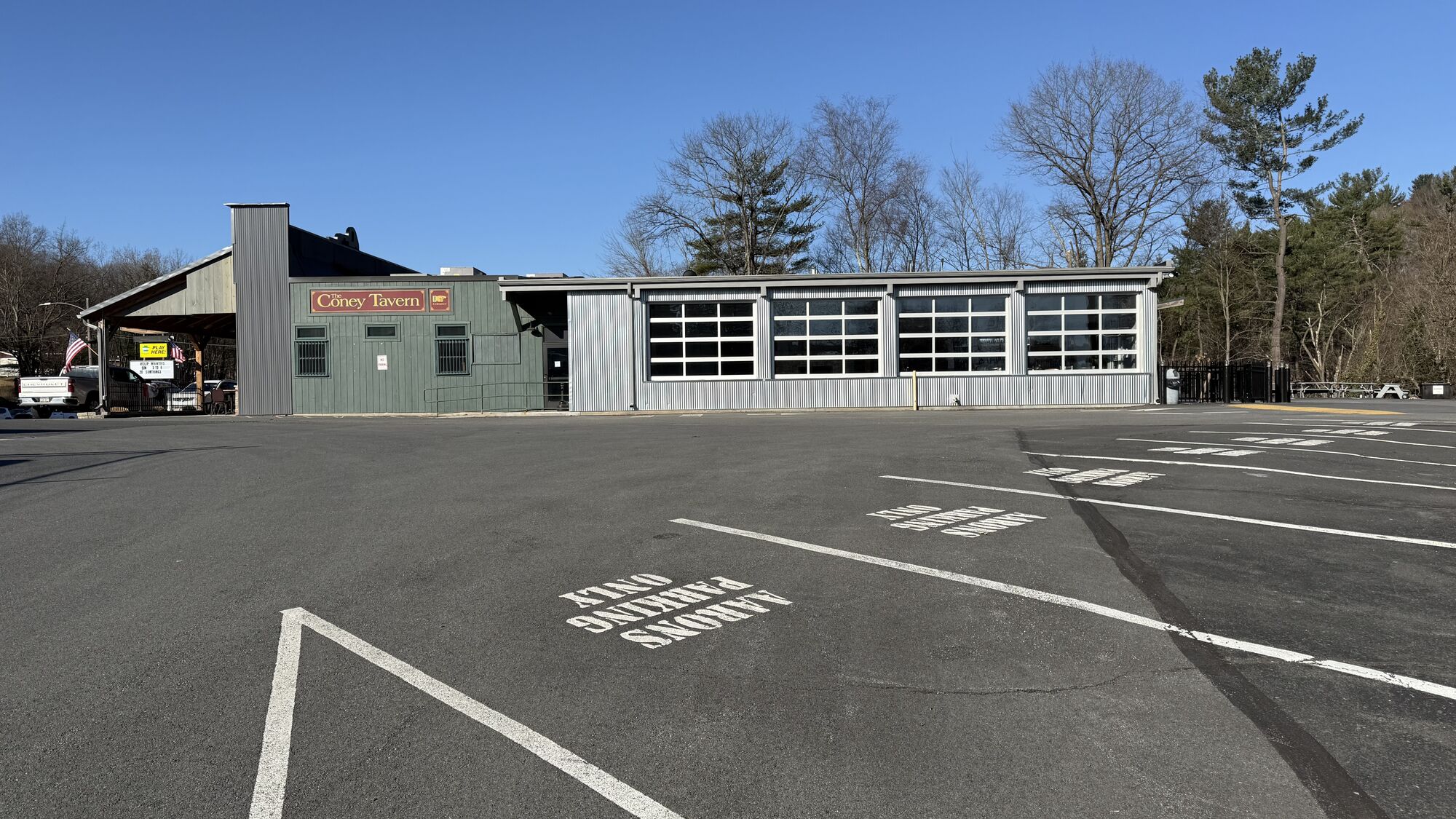 Exterior of the four-season patio at The Coney Island in Pottsville, PA, with the roll-up glass garage doors open in warm weather.