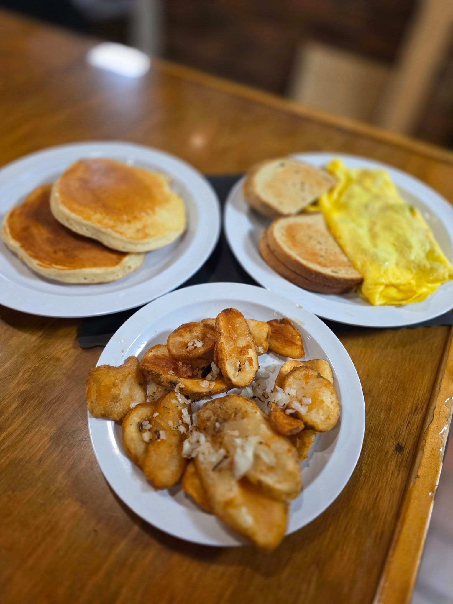 Breakfast at The Coney Island in Pottsville, PA — pancakes, an omelette, and home fries on a diner plate.