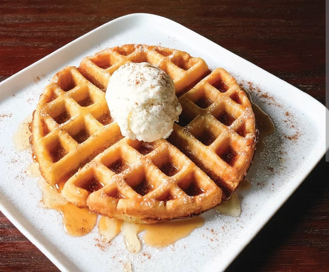 A Belgian waffle with a scoop of ice cream and maple syrup at The Coney Island in Pottsville, PA.