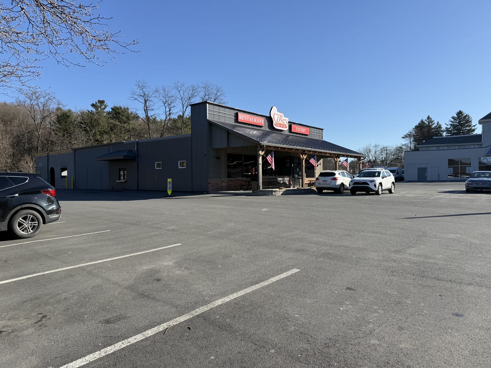 Acres of open, free parking wrapping The Coney Island in Pottsville, PA, in daylight.